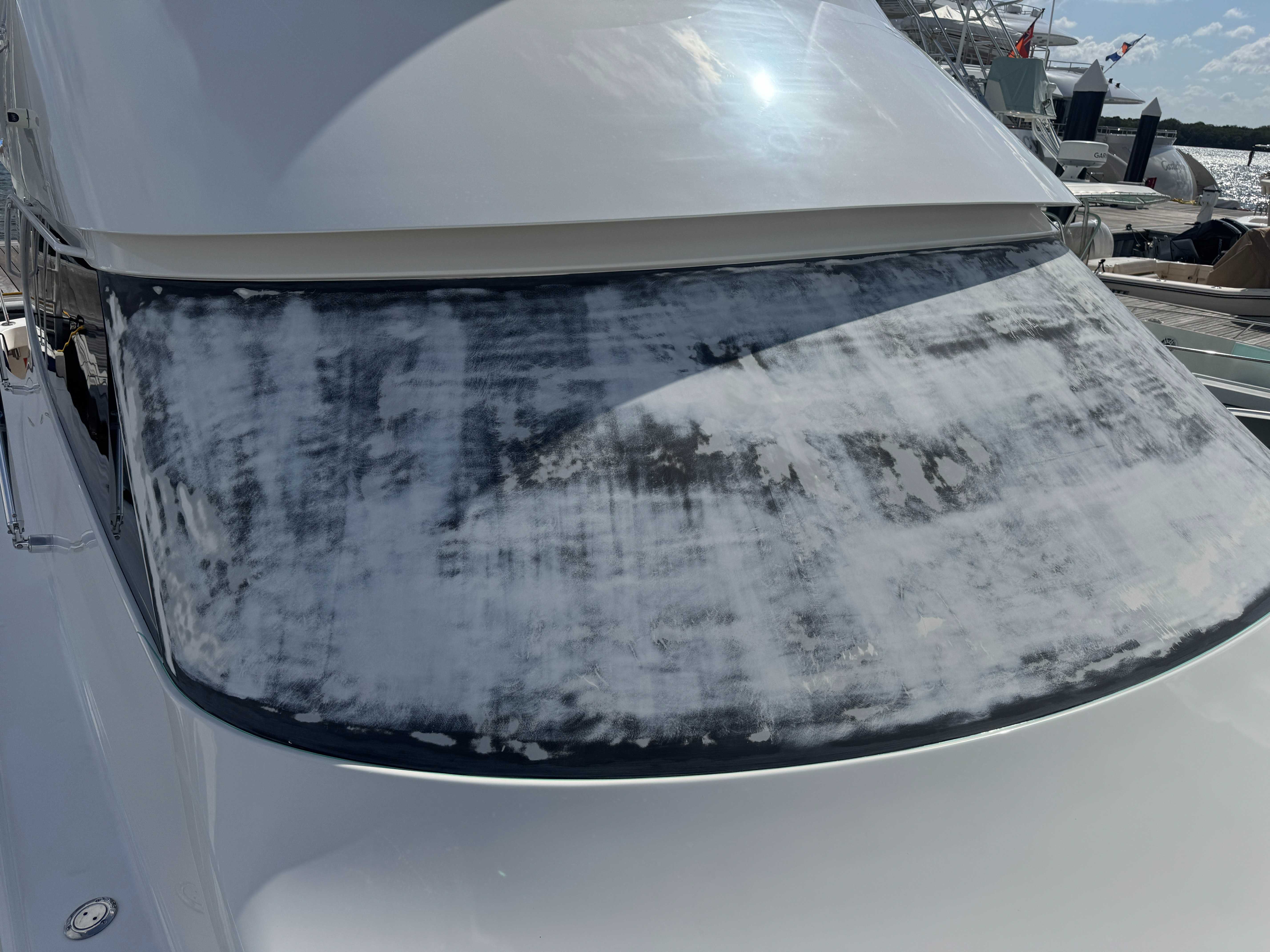 Elegant brow wrap installation enhancing the sleek lines of this luxury yacht. Professional grade materials with extended warranty.